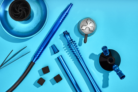 Top view of Hookah parts on light blue background. Still life. Copy space. Flat lay