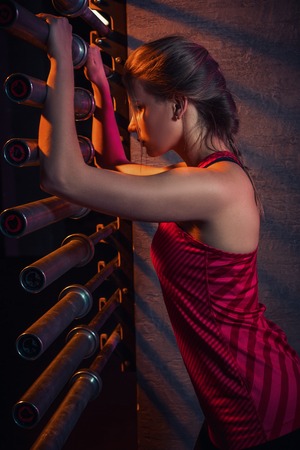 Young beautiful woman posing in a gym outfit.の写真素材