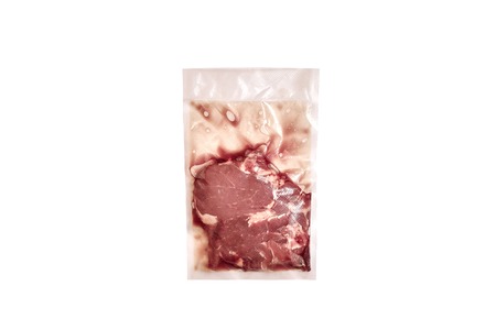 Unopened pack of 1 raw beef steaks isolated on white background. Delivery of steaksの写真素材