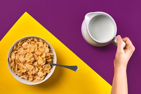 Food, healthy eating, people and diet concept - close up of woman eating muesli with milk for...