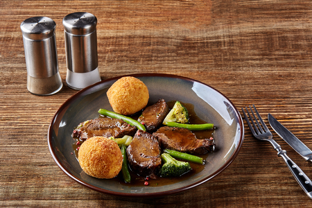Stewed beef with vegetables on wooden background close up. Hot Meat Dishes. Top view. Still life. Copy space. Flat lay. Concept restaurant menuの写真素材