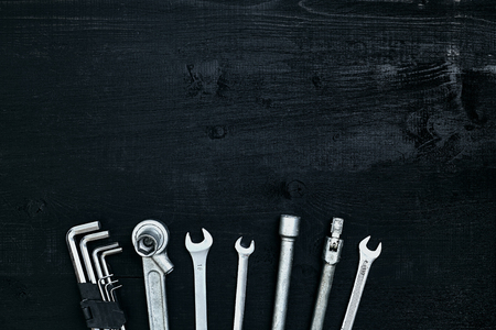 Tools for work or repair auto on black wooden background. Top view. Still life. Copy space. Flat layの写真素材