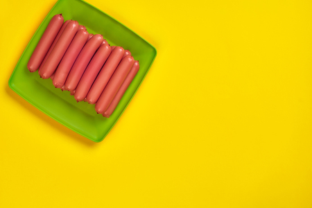 Sausages on a yellow background. Flat lay. top view.の写真素材