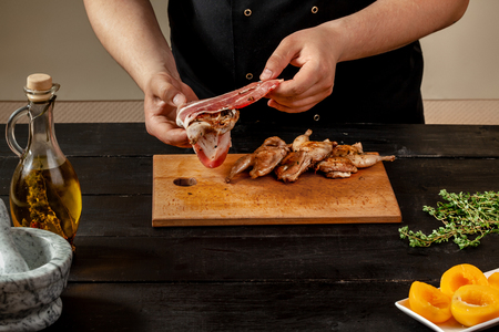 Preparing quail specialty, rolling quail with baconの写真素材
