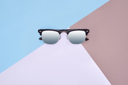Minimal style. Minimalist Fashion photography. Fashion summer is coming concept. Sunglasses on a colorful backgroundの写真素材