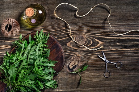 Fresh green arugula on wooden tableの写真素材
