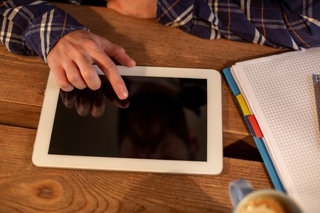 Man using tablet works. White tablet with blank screen in a man handsの写真素材