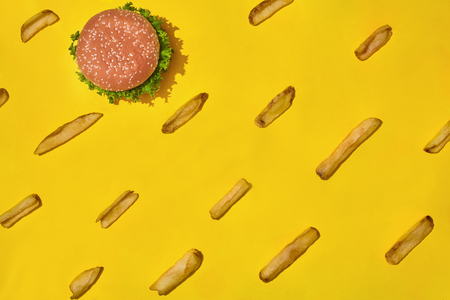 Design concept of mockup burger and french fries set on yellow background. Top View with Copy Space. Pattern. Flat lay.の写真素材