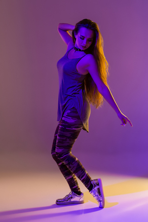 Modern style dancer posing on studio background. Color filtersの写真素材