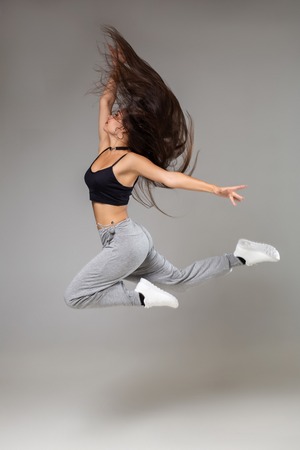 Modern style dancer posing on studio background. Hip hop, jazz funk, dancehallの写真素材