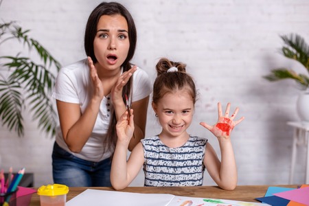 Happy family. Mother and daughter together paint.の写真素材