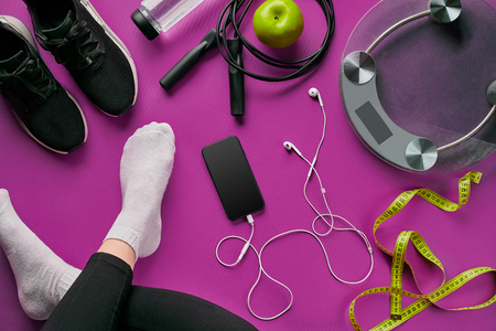 Flat lay gym equipment such as jump rope, bottle of waters, smartphone with headphoneの写真素材