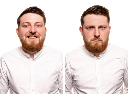 Studio portrait of young handsome smiling and serious ginger man with beardの写真素材