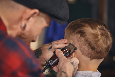 Caucasian boy getting haircut in barbershop indoorの写真素材