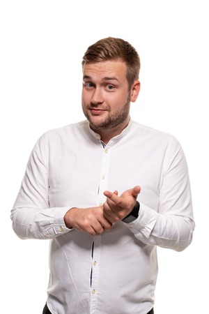 Close up horizontal portrait of a handsome man with a beard, stylish haircut, wearing a white shirt, isolated on a white backgroundの写真素材
