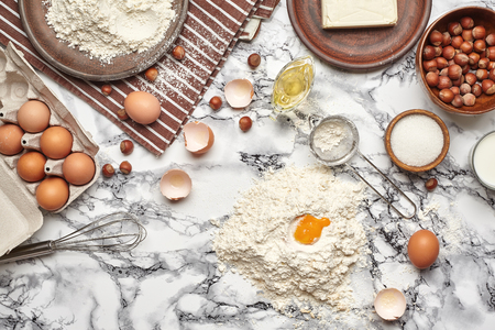 Close-up shot. Top view of a baking ingredients and kitchenware on the marble table background.の写真素材