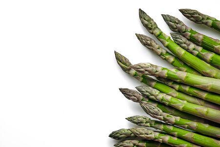 An edible, raw stems of asparagus isolated on white background.の写真素材