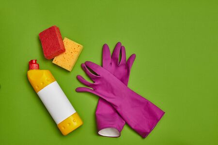 Detergents and cleaning accessories on a green background. Housekeeping concept.の写真素材
