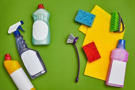 Detergents and cleaning accessories on a green background. Housekeeping concept.の写真素材