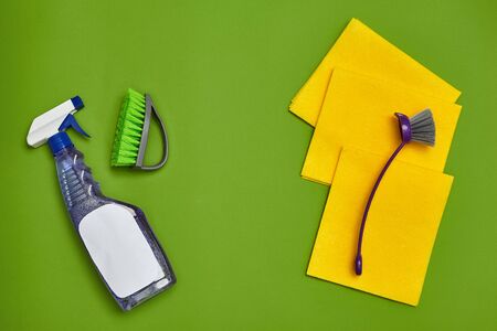 Detergents and cleaning accessories on a green background. Housekeeping concept.の写真素材