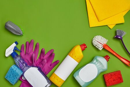 Detergents and cleaning accessories on a green background. Housekeeping concept.の写真素材