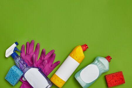 Detergents and cleaning accessories on a green background. Housekeeping concept.の写真素材