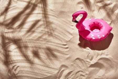 Traveler vacation accessories are laid out on a white beach sand. Flat lay, top view.の写真素材