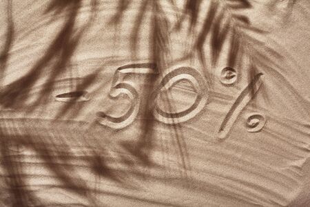 Summer concept with a shadow of a tropical palm tree leaves, copyspace on a white beach sand.の写真素材