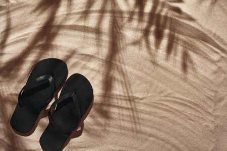 Traveler vacation accessories are laid out on a white beach sand. Flat lay, top view.の写真素材