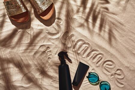 Traveler vacation accessories are laid out on a white beach sand. Flat lay, top view.の写真素材