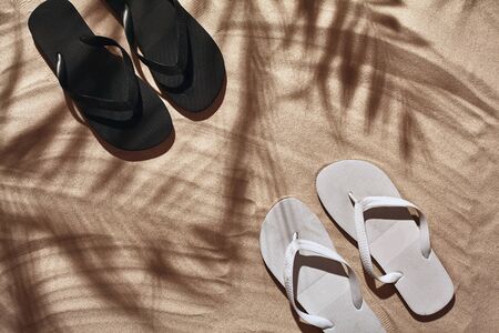 Traveler vacation accessories are laid out on a white beach sand. Flat lay, top view.の写真素材