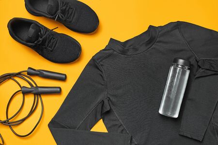 Close-up studio shot of a gym accessories on a yellow background. Top view, flat lay.の写真素材