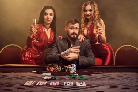 Group of a young wealthy friends are playing poker at a casino.の写真素材