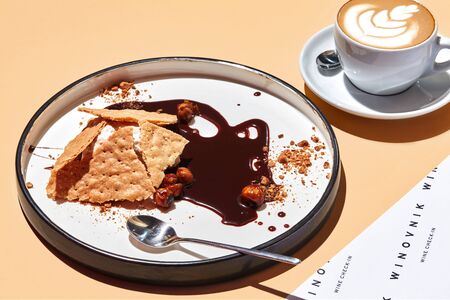 Vanilla ice-cream with crunchy biscuits and hazelnuts, drenched in dark chocolate.の写真素材