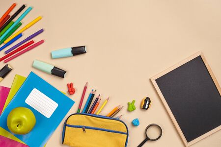 Flat lay photo of workspace desk with school accessories or office supplies.