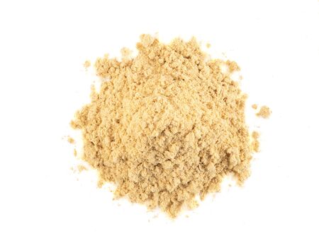 Small pile of a ground mustard isolated on white background with copy space for text or images. Spices and herbs. Food, cooking, restaurant, packaging concept. Frame composition, close-up, top view.の写真素材