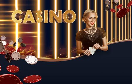 Woman in black dress, jewelry. Showing two aces, smiling, posing on colorful background with golden inscription casino and flying chips. Poker, casinoの写真素材