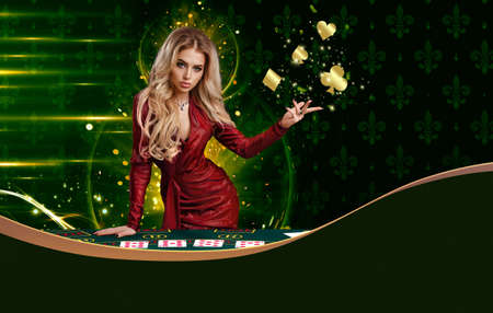 Blonde woman in red dress is showing golden flying suits of cards, leaning on playing table, posing on colorful background. Copy space. Poker, casinoの写真素材