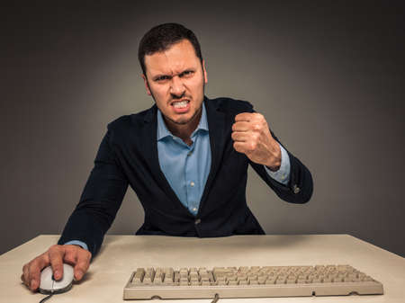 Portrait angry upset young man in blue shirt and jacketの写真素材