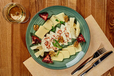 Platter of Georgian cheeses with spicy oil, pomegranate, walnutsの写真素材
