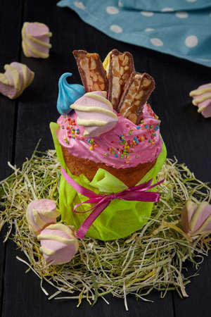 Easter cake with pink whipped egg whites icing and sweets