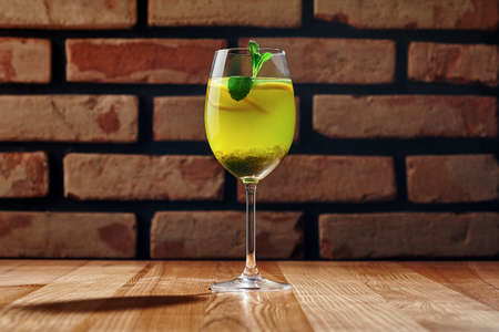 Glass with non-alcoholic citrus cocktail with fresh mint