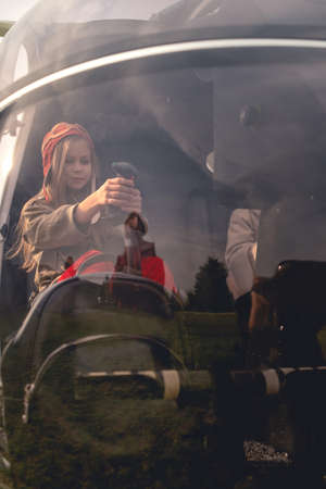 Focused preteen girl imitating helicopter control on co-pilot seatの写真素材