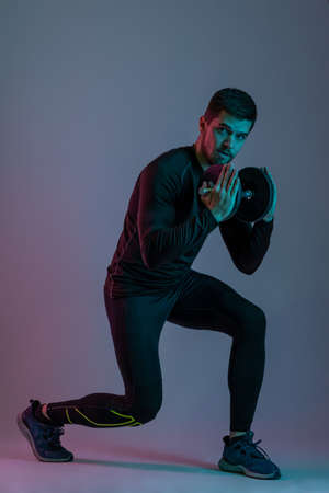 Trainer demonstrating technique of performing lunges with dumbbellの写真素材