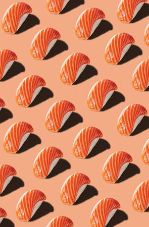 Food pattern of nigirizushi with salmon on pinkish backgroundの写真素材
