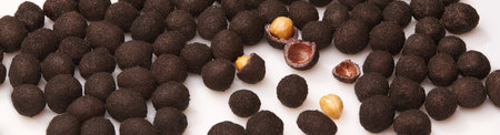 Glazed peanuts in sweet shell with cocoa on whiteの写真素材