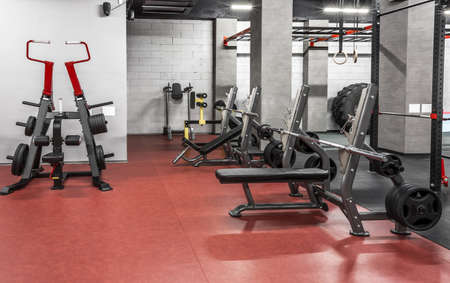 Various powerlifting equipment in spacious, well lit, empty gym interior. Special modern exercise machines for physical training. Sport, fitness. Healthy lifestyle conceptの写真素材