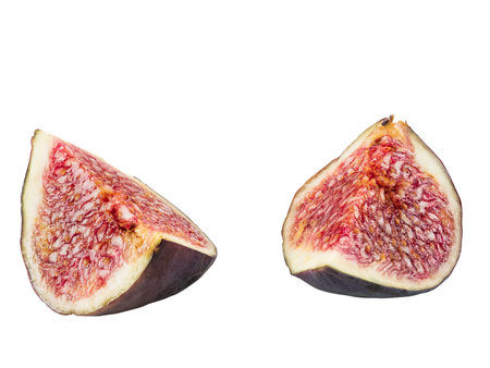 Two slices of purple fig isolated on white background with copy space. Soft, sweet fruit, skin is thin, red flesh has many seeds. Close-up.の写真素材