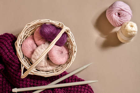 Balls of woolen threads and knitting needles. Scandinavian style. Threads for knitting in a basket.の写真素材