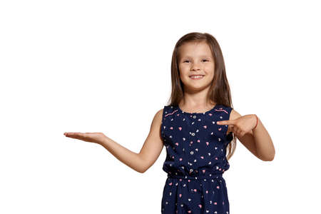 Close-up studio shot of beautiful brunette little girl posing isolated on white studio background.の写真素材